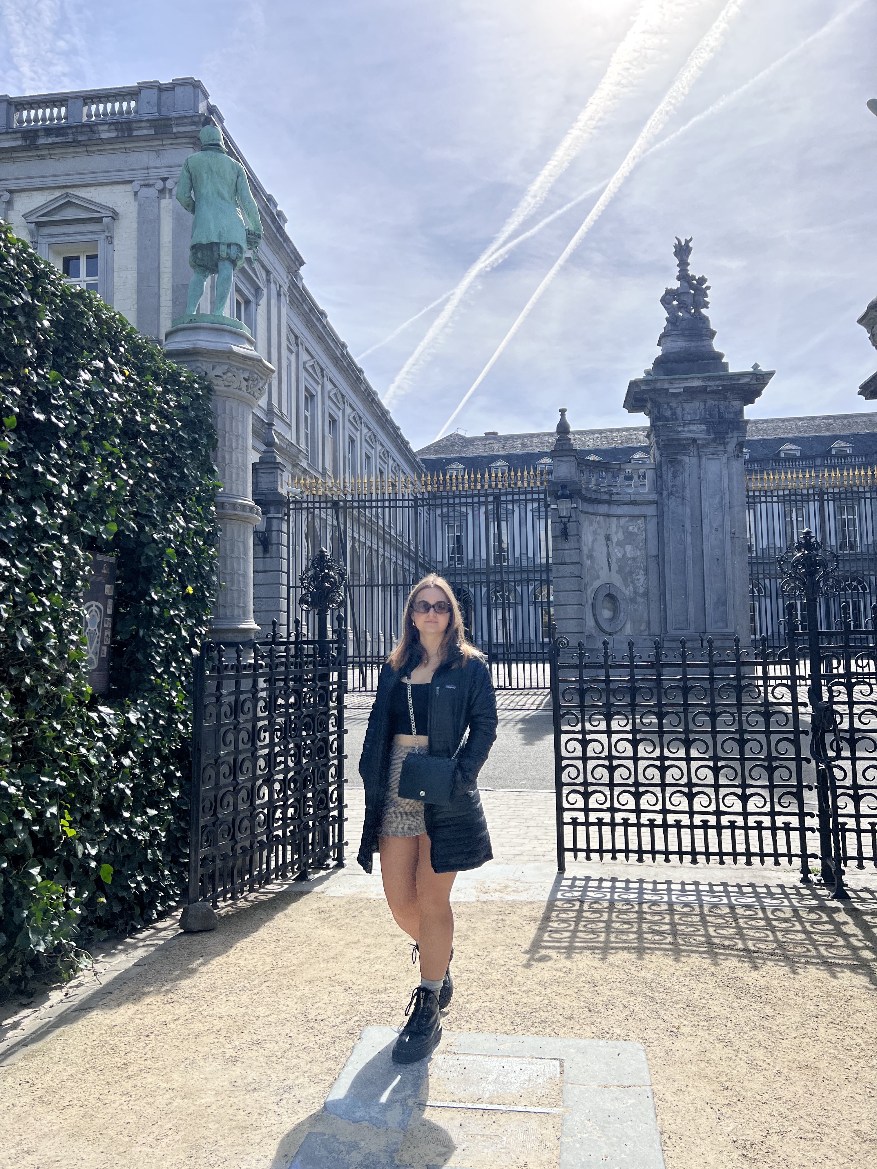 Emily walking through gardens in Brussels.